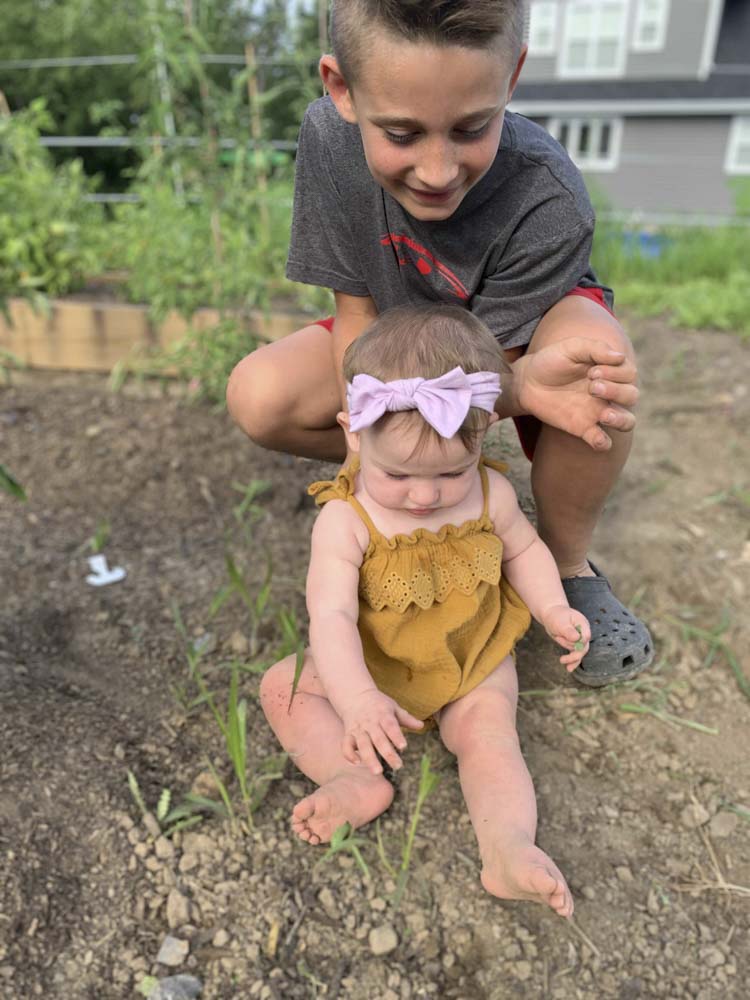 two children playing in the dirt