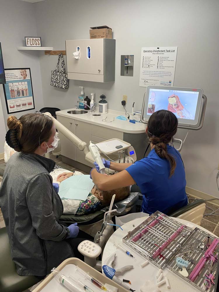 dentist taking an intraoral scan of a patient's mouth