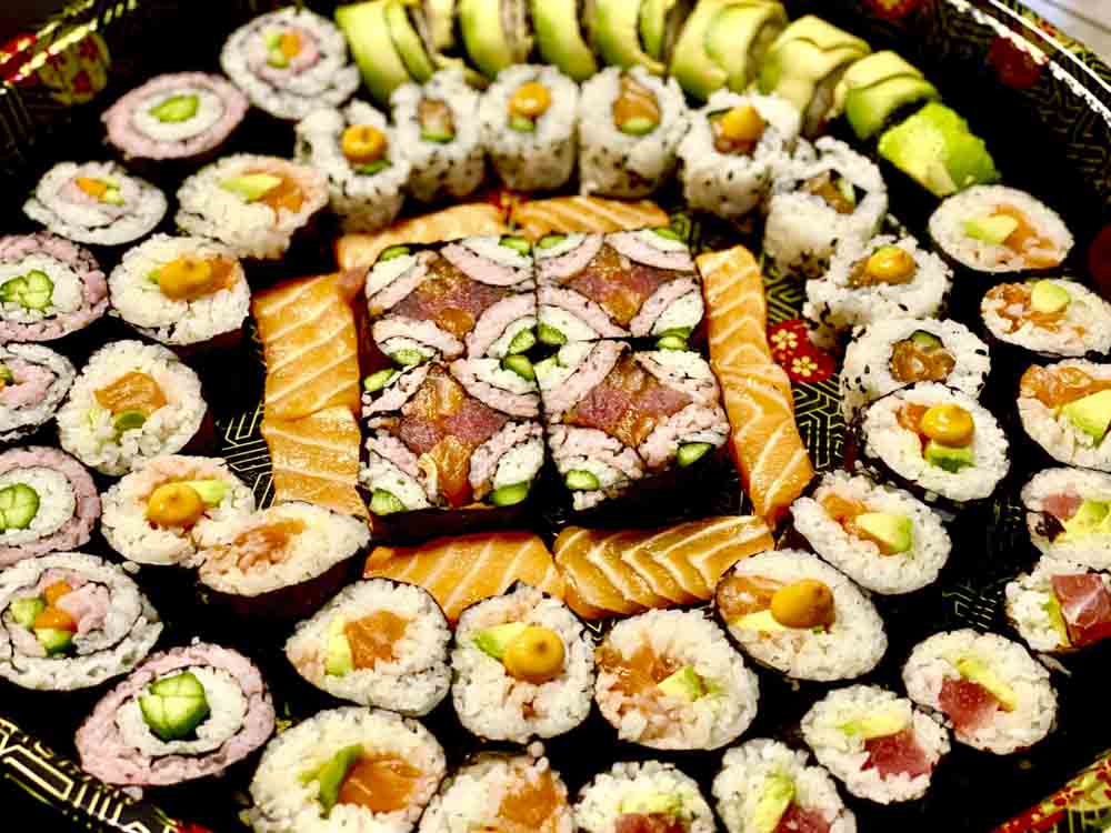 variety of sushi rolls on a serving platter