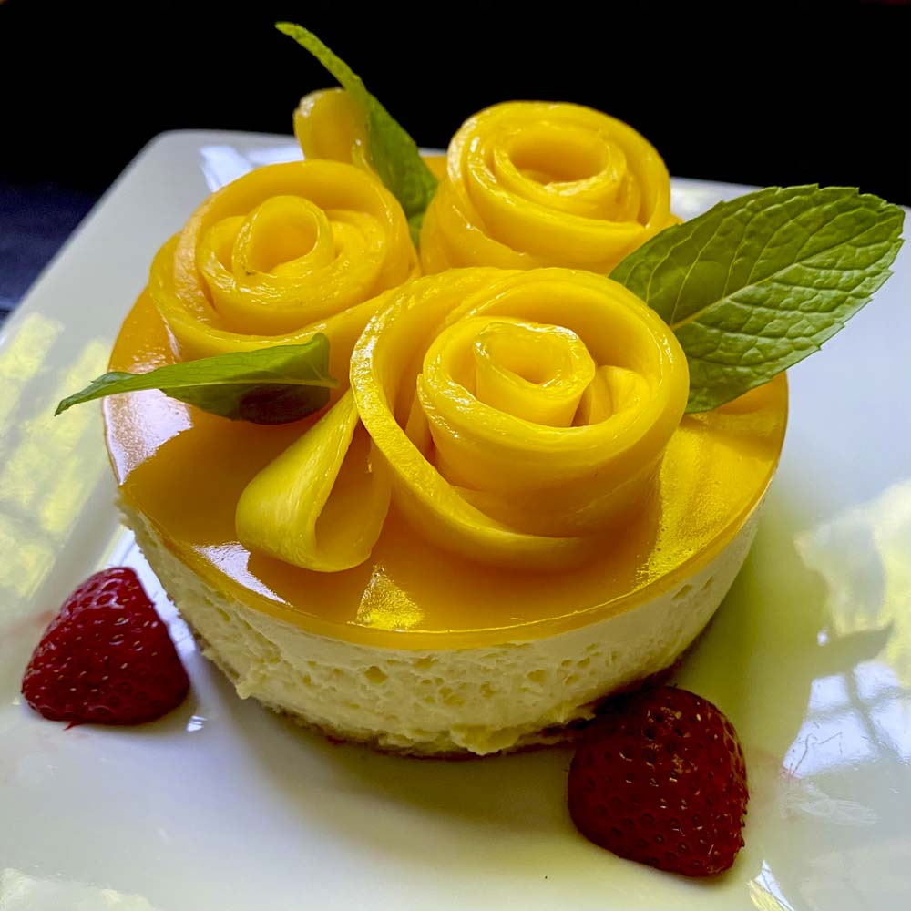 cheesecake with three flowers made out of custard on top