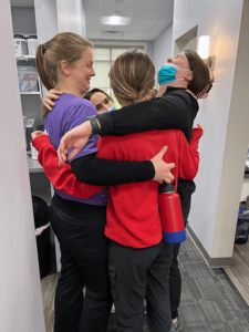 finger lakes dental henrietta team hugging